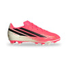 Pink and beige soccer cleat with black stripes on a white background