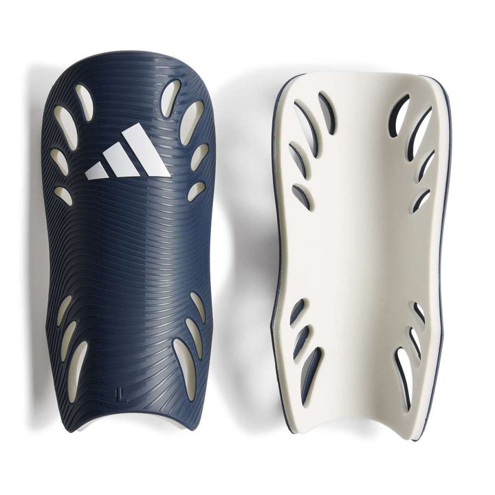 Two shin guards, one navy with white Adidas logo and one beige, on a white background.