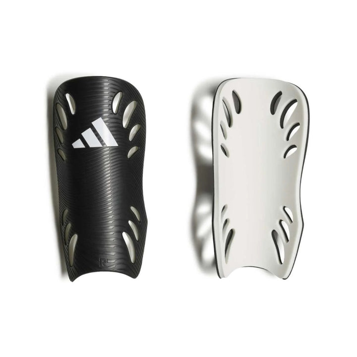 A pair of Adidas soccer shin guards shown side-by-side against a white background, one in textured black with a white Adidas logo, and the other in white with black trim.
