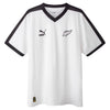 White sports jersey with black accents and Puma logo on a white background