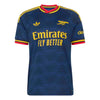 A dark blue Arsenal football jersey with yellow and red accents, featuring the Adidas logo, Arsenal crest, and Emirates Fly Better sponsor text.