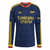 A long-sleeve Arsenal football jersey in navy blue with yellow and red accents, featuring the Adidas logo, Arsenal crest, and Emirates Fly Better sponsor text.