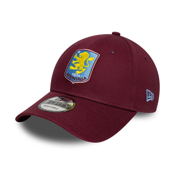 A maroon New Era 9FORTY baseball cap featuring the Aston Villa football club crest on the front and a silver metallic size sticker on the brim, set against a plain white background.