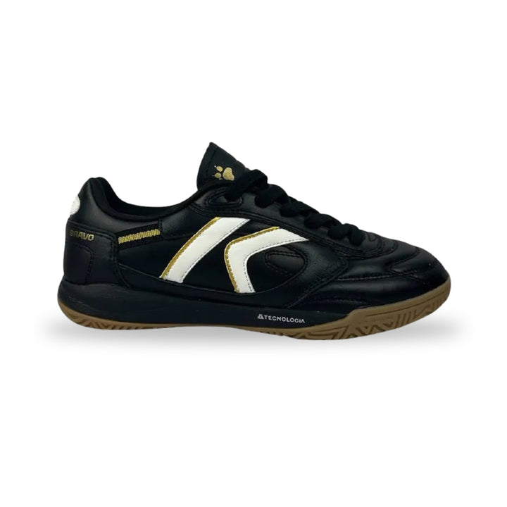 A black leather indoor soccer shoe with a white and gold side stripe, black laces, and a brown gum sole, shown against a plain white background.