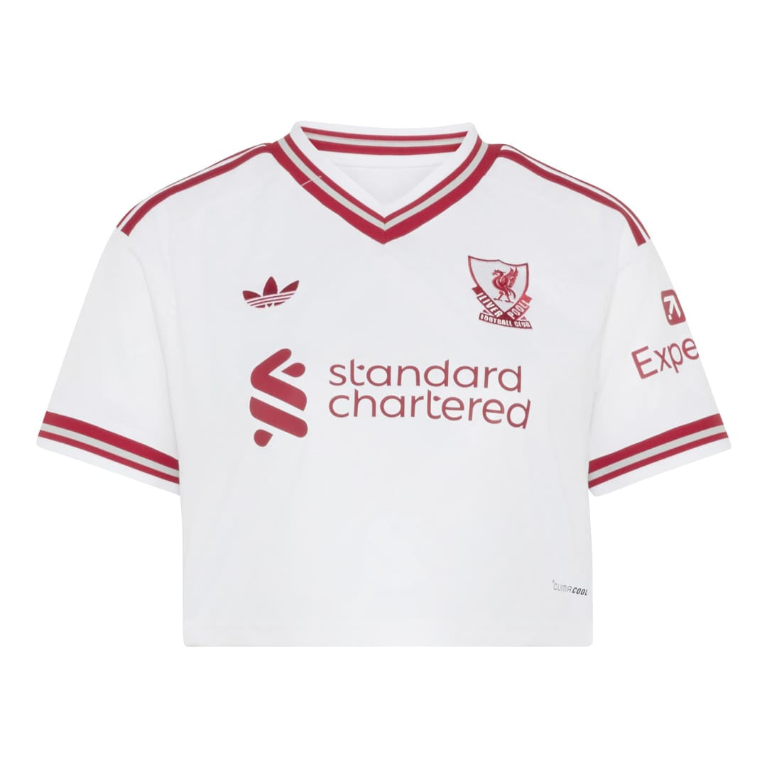 A white short-sleeve soccer jersey with red stripes and logos, featuring the Liverpool club crest, Adidas logo, and Standard Chartered sponsor logo.