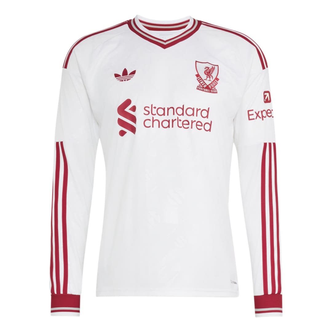 A white long-sleeve Adidas Liverpool football jersey with red stripes and logos, featuring the Liverpool club crest and Standard Chartered sponsor on the front.