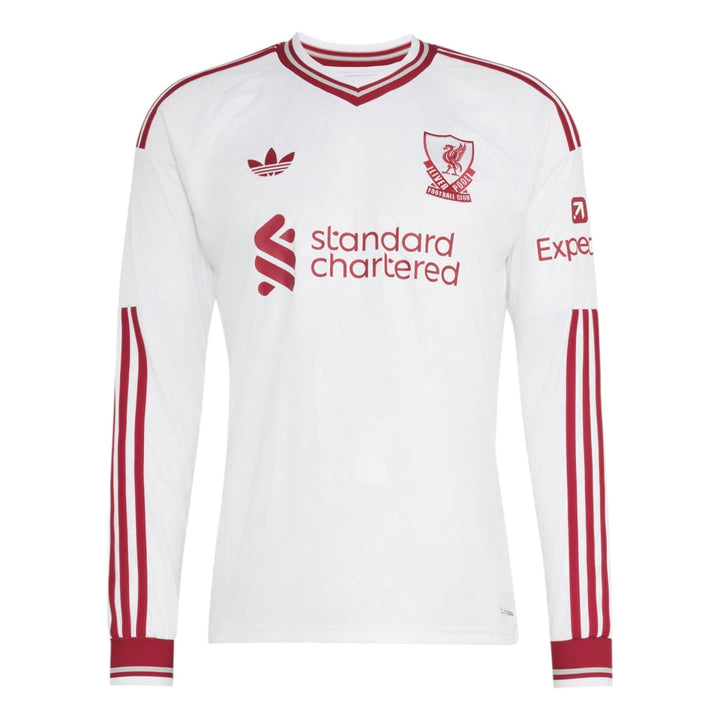 A white long-sleeve Adidas Liverpool football jersey with red stripes and logos, featuring the Liverpool club crest and Standard Chartered sponsor on the front.