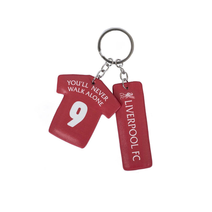 A red Liverpool FC soccer jersey keychain featuring a T-shirt charm with the number 9 and the text 'YOU'LL NEVER WALK ALONE', alongside a rectangular tag with 'LIVERPOOL FC' branding, attached to a silver metal keyring on a white background.