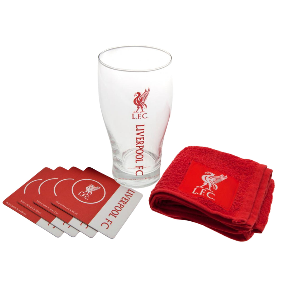 Liverpool FC themed gift set featuring a clear pint glass with the red LFC logo and text, four red coasters with white borders, and a folded red towel, all arranged on a white background.