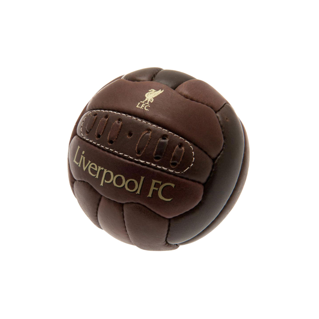 A miniature brown leather soccer ball featuring the Liverpool FC crest and 'Liverpool FC' text in gold, isolated on a white background.