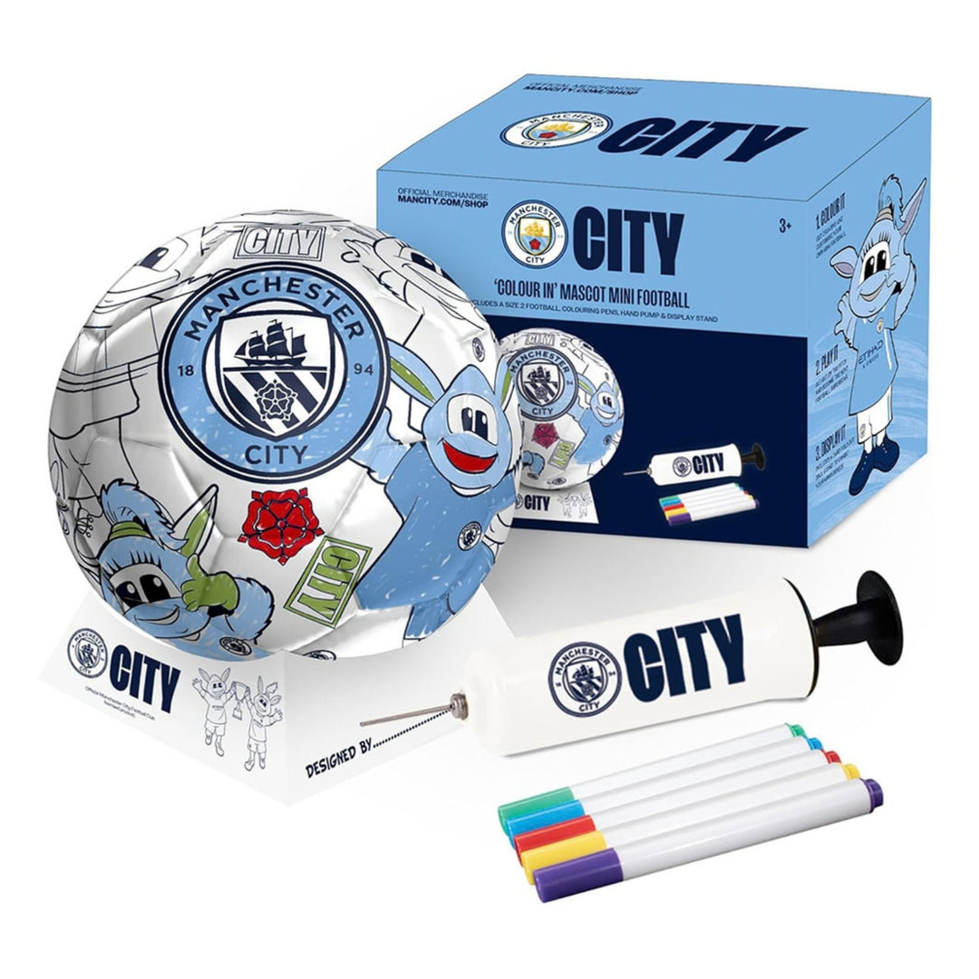 Manchester City themed mini football kit including a metallic silver and blue printed football, branded box, hand pump, and five paint markers on a white background.