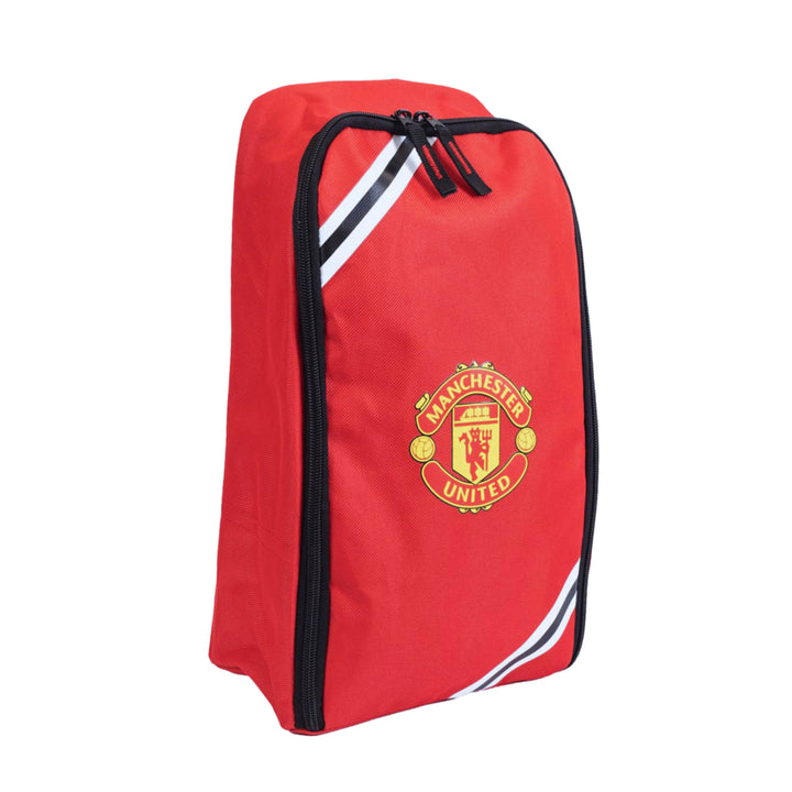A red Manchester United zippered shoe bag with white and black diagonal stripes and the club's crest on the front, set against a plain white background.