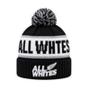 Black beanie with pom-pom and 'All Whites' branding on a white background