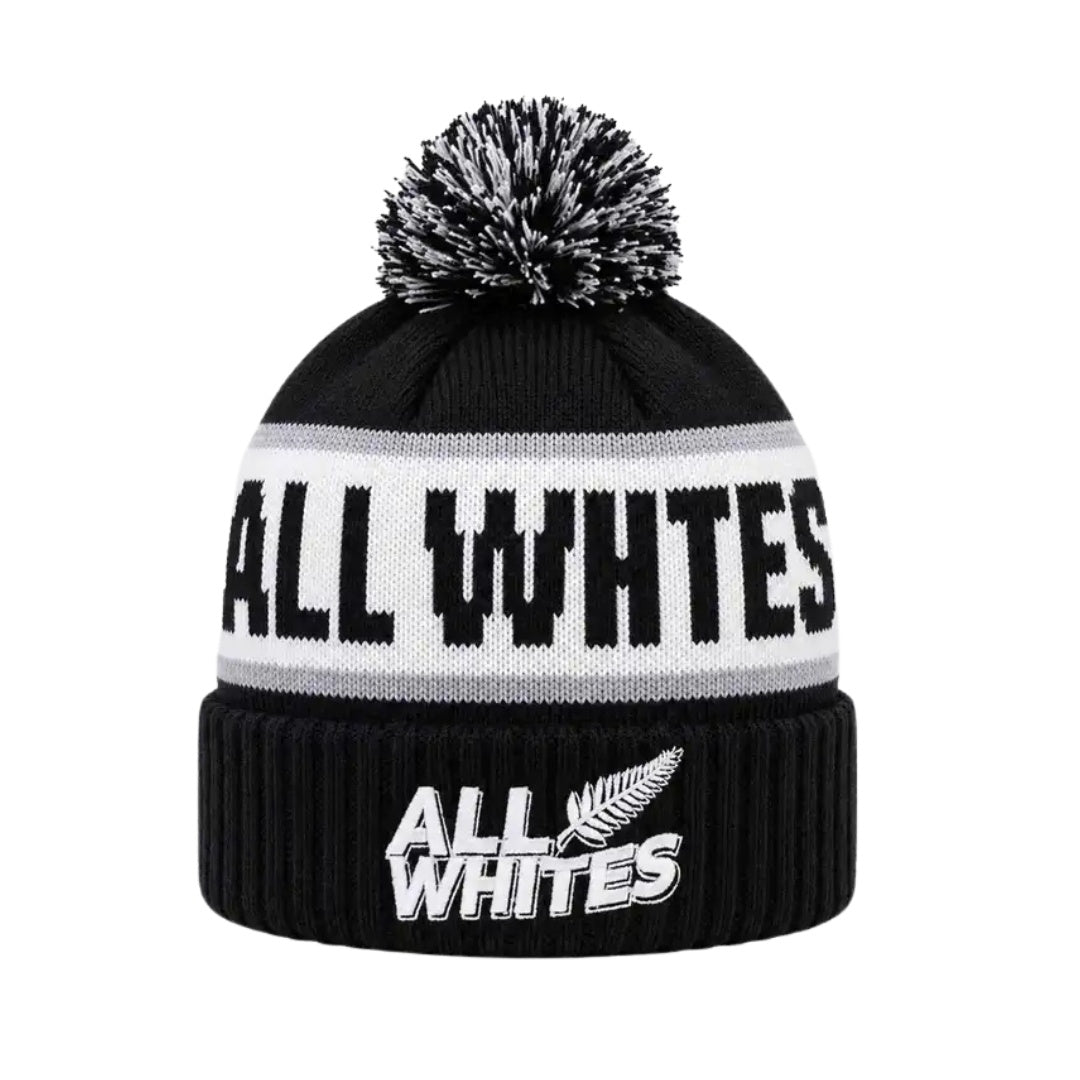 Black beanie with pom-pom and 'All Whites' branding on a white background