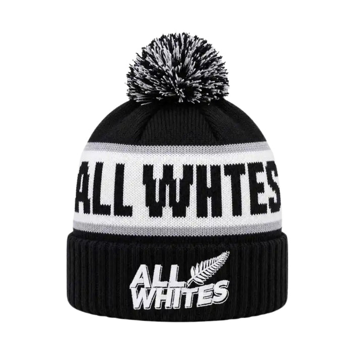 Black beanie with pom-pom and 'All Whites' branding on a white background