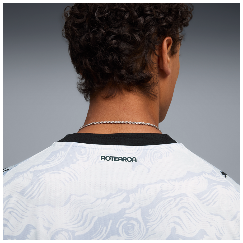 Close up view of person wearing NZ All Whites Shirt with Aotearoa on the collar