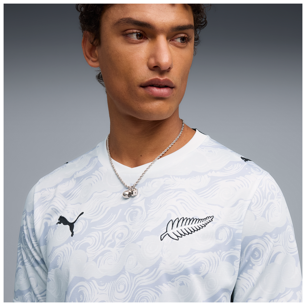 Close up of person wearing NZ All Whites football jersey