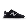 Black Adidas sneaker with white stripes on a light gray background