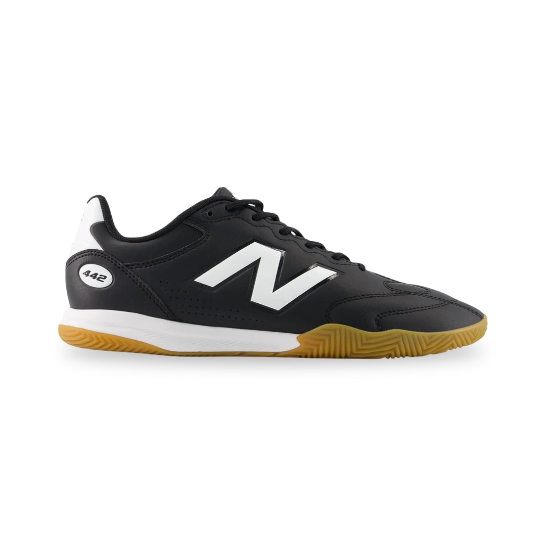 Black sneaker with white logo and brown sole on a white background