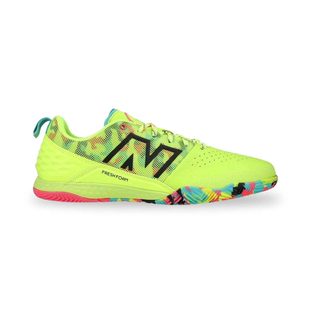 Neon green athletic shoe with colorful sole on a white background