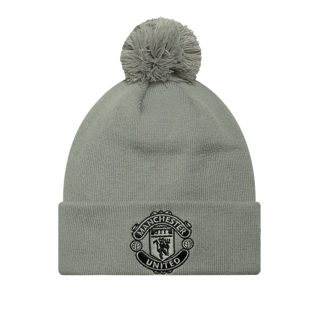 Gray beanie with pom-pom and Manchester United logo on a white background