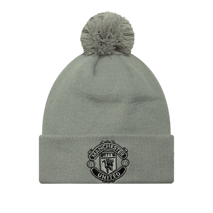 Gray beanie with pom-pom and Manchester United logo on a white background