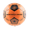 An orange soccer ball with black panels featuring the Newcastle United crest and the text 'NEWCASTLE UNITED' printed across the front, shown on a plain white background.