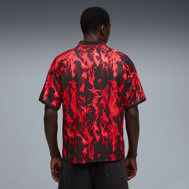 Person wearing a red and black patterned shirt on a gray background