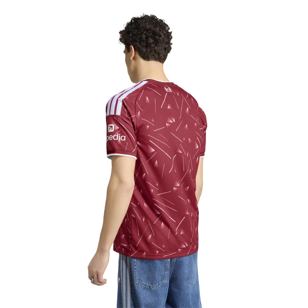 Person standing wearing Liverpool FC Home Jersey facing away