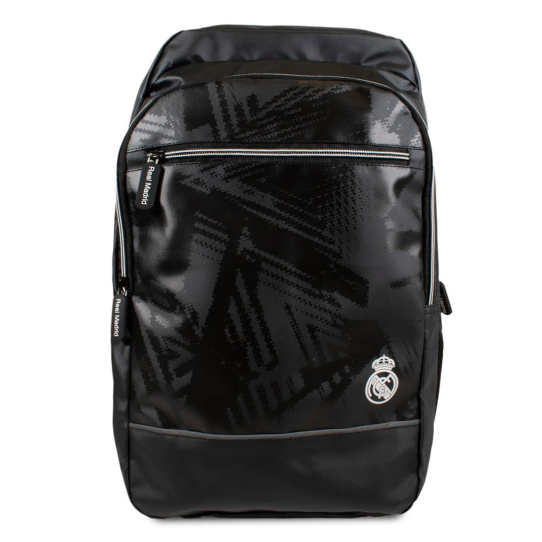 A black Real Madrid backpack with a glossy finish and a subtle geometric pattern, featuring the Real Madrid crest on the front pocket.