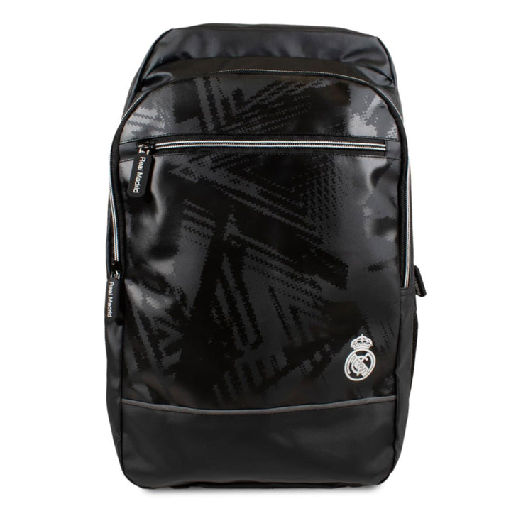 A black Real Madrid backpack with a glossy finish and a subtle geometric pattern, featuring the Real Madrid crest on the front pocket.