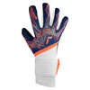A single soccer goalkeeper glove shown from the back, featuring a navy blue backhand with geometric orange and light blue patterns, white finger sides, a white wrist strap, and bright orange accents.